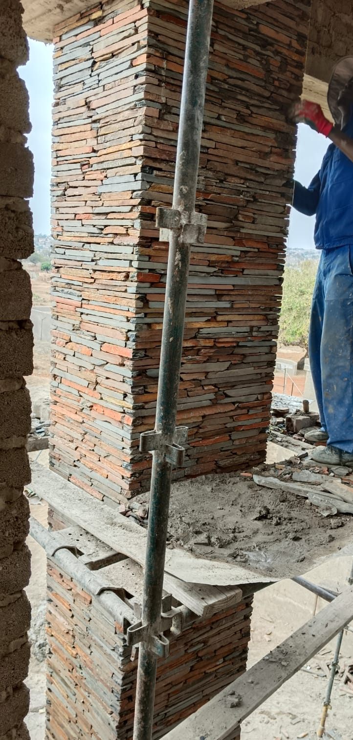 Pillar being clad from scaffolding