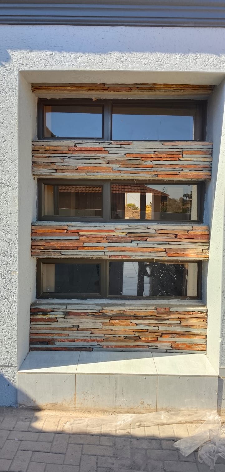 Slate cladding between window panes